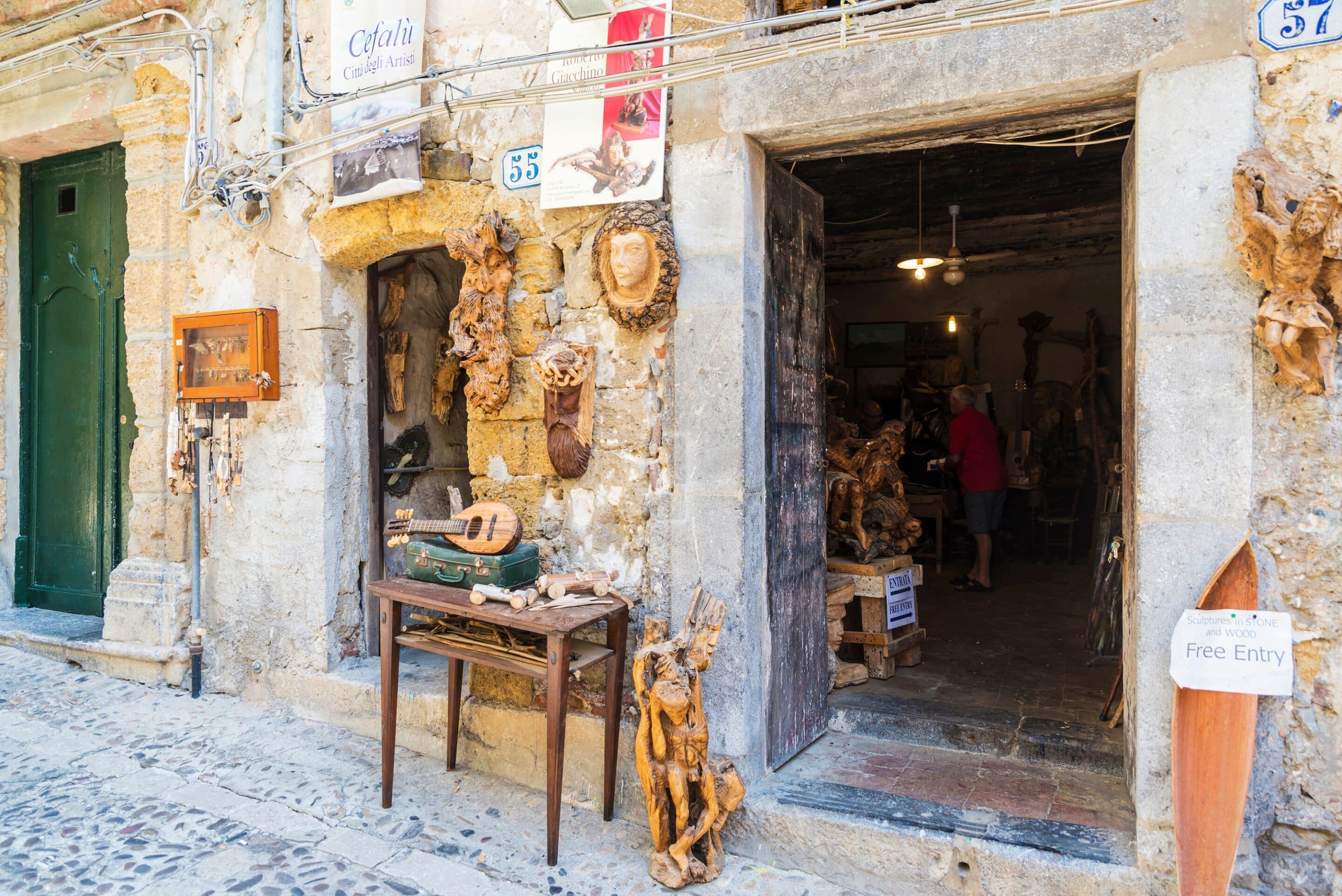 A rustic stone storefront located in Cefalù, Sicily